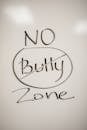 A handwritten motivational message on a whiteboard promoting a no-bullying zone.